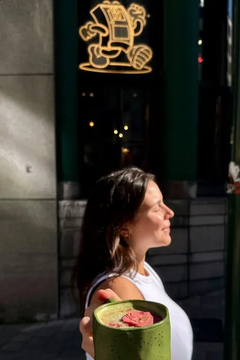 Customer enjoying a matcha latte outside The Unusual